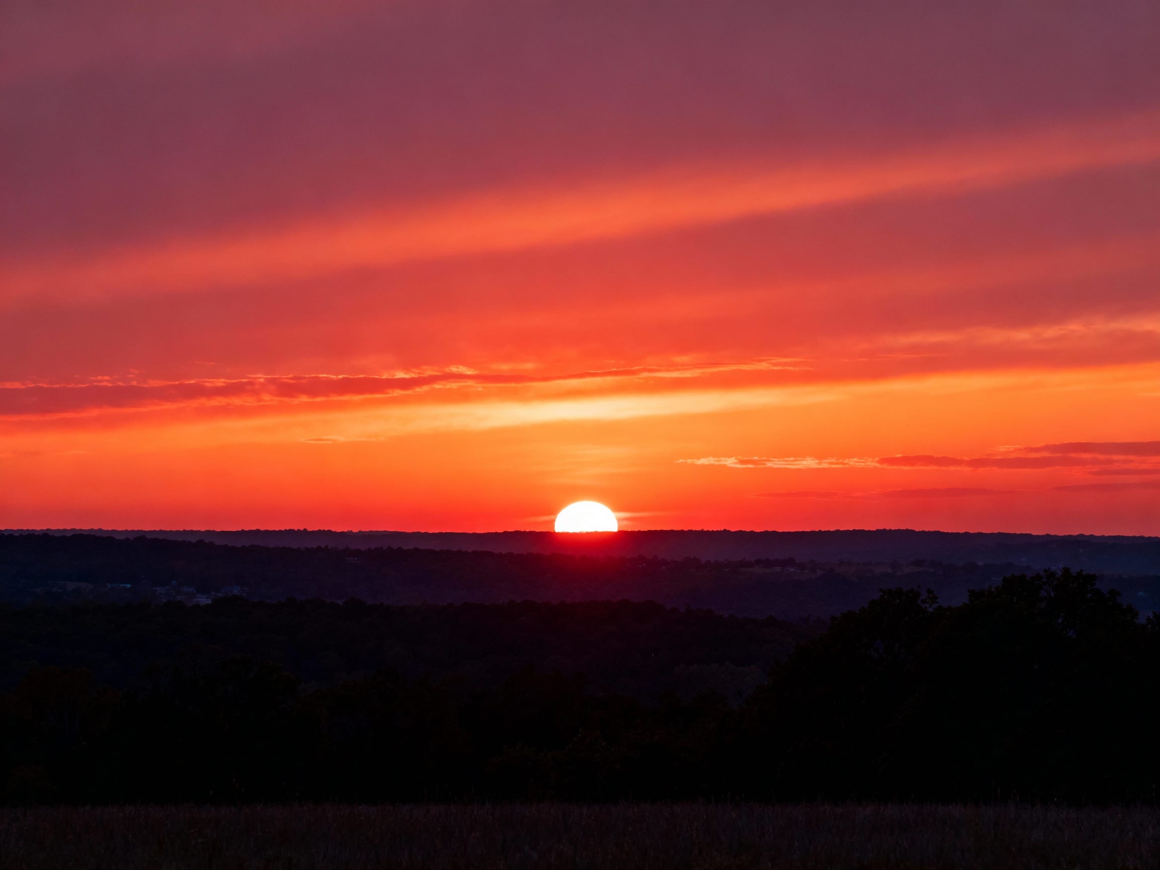 the same sunset photo as before, but with the Snapchat caption seamlessly removed by ClearCrowds